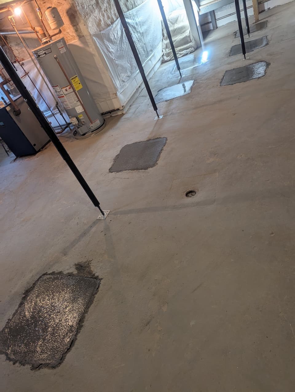Patched floor cutouts after pier installation