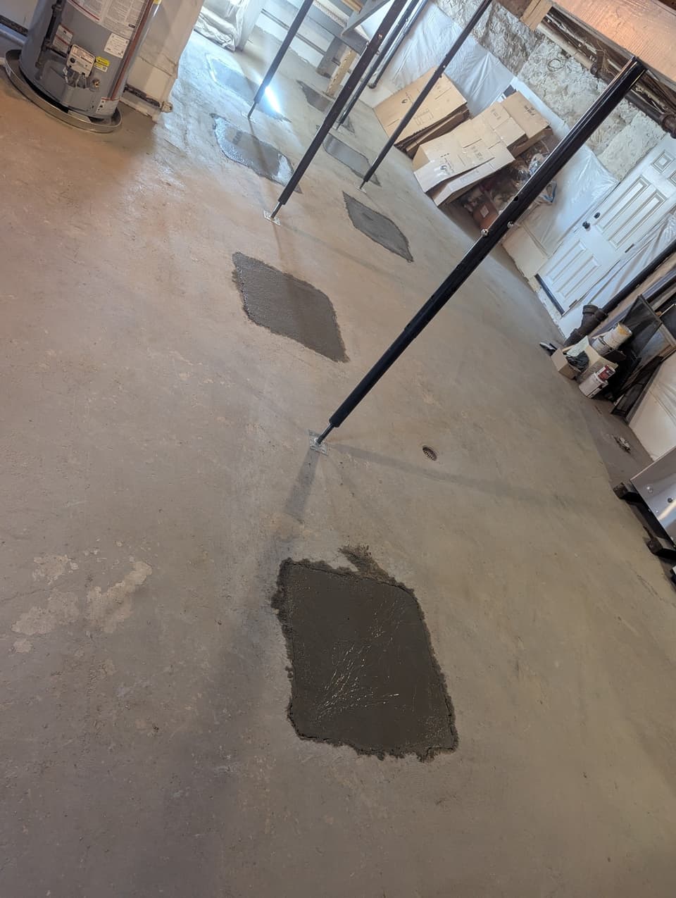 Adjustable steel jacks installed to support the floor framing