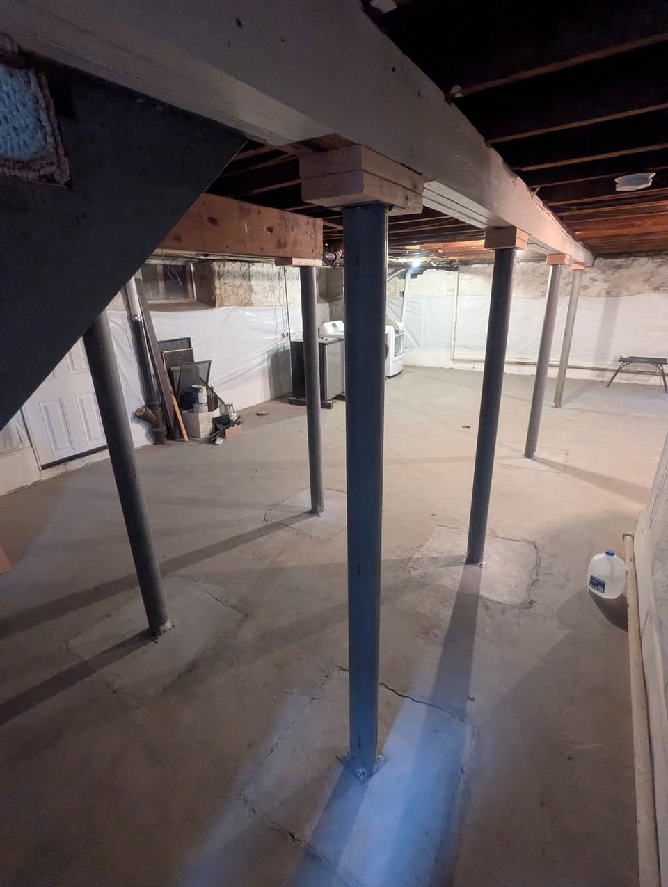 Steel columns supporting floor framing in a commercial basement