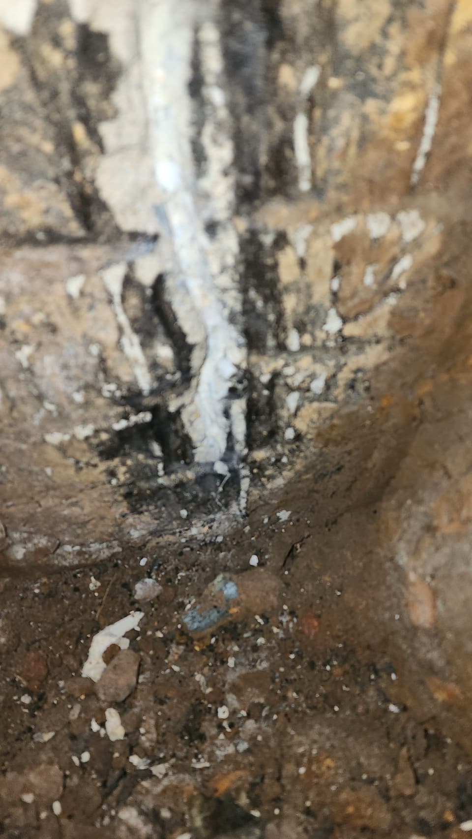 Exterior foundation crack being repaired