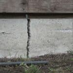 Close-up of a deep residential house foundation crack